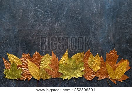Autumn Metallic Gold Copper Leaf Frame. Different Fall Metallic Paint Leaves On Dark Natural Backgro