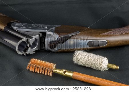 Shotgun And Gun Cleaning Items On A Baize Table Top