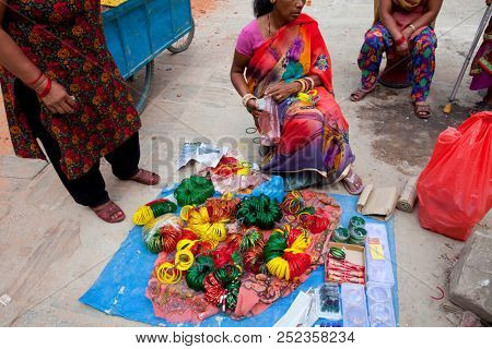 KATHMANDU, NEPAL - JULY 17, 2018: Unidentified Nepal person selling in local market in the Thamel district, Kathmandu. Thamel is a tourist district with many hotels, souvenir shops, restaurants