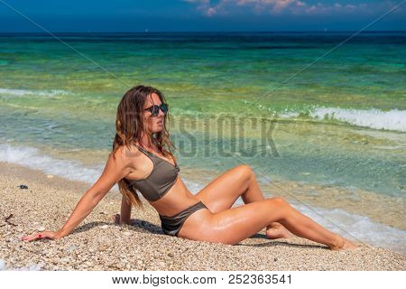 woman sunbathing on the beach summer travel holidays