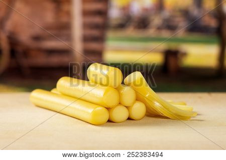 Lot Of Whole One Piece Of Smoked Slovak String Cheese Stick With Cart In Background