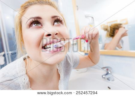 Woman Brushing Cleaning Teeth Closeup. Funny Blonde Girl With Toothbrush In Bathroom. Oral Hygiene. 