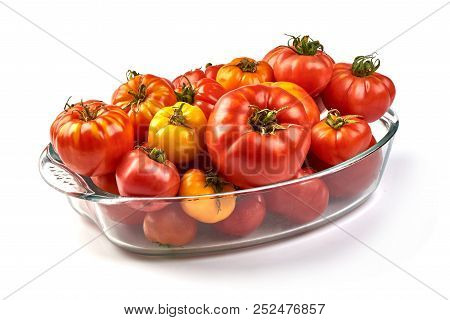 Colorful Yellow And Red Tomatoes Of Different Sizes And Kinds In A Glass Container, Isolated On Whit