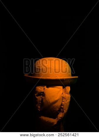 Hat On A Hanger In The Dark. Classic Hat On Coat Rack Isolated On Black.