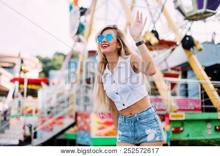 Stylish Happy Young Woman Wearing Short Denim Shorts And A White T-shirt. Brightred Lips . Portrait 