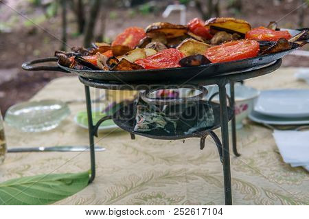 Saj Kebap With Mushrooms Chicken. Outdoor Picnic Table.
