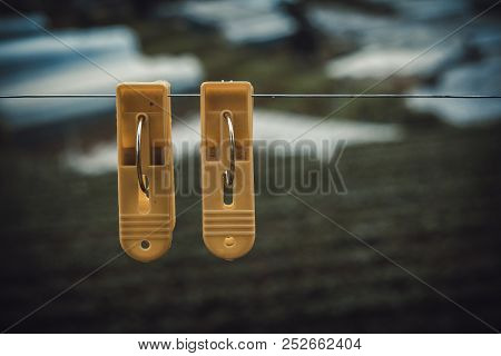 Couple Plastic Clothes Peg. Royalty High Quality Stock Photo Of Two Yellow Plastic Clothes Peg Cloth