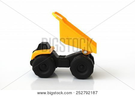Isolated Toy Truck In Yellow And Black Colors With White Background