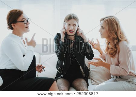 Upset Teenage Daughter In Jacket In Psychologist Office With Mother. Punk In Lather Jacket. Communic