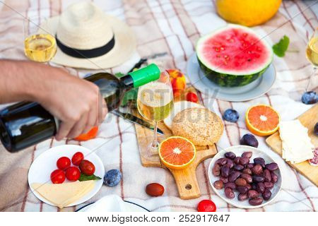 Summer Picnic Basket On The Green Grass. Food And Drink Concept. Friends Party Time