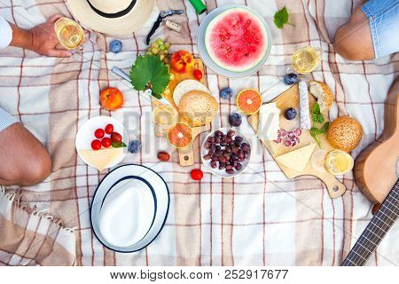 Summer Picnic Basket On The Green Grass. Food And Drink Concept. Friends Party Time