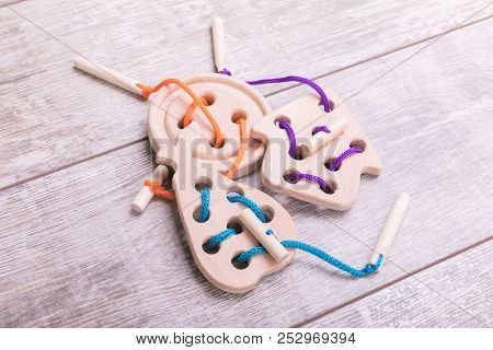 Constructor Figures In Different Colours. Wooden Background