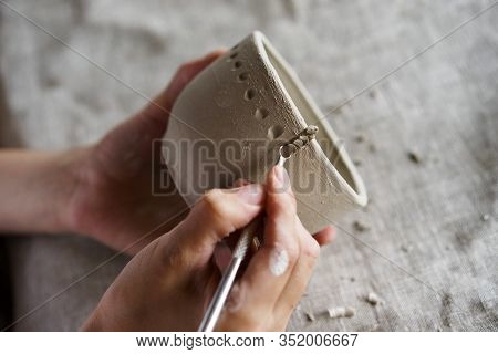 Female Hands Hold A Bowl For Casting Clay Products