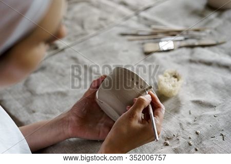 Female Hands Hold A Bowl For Casting Clay Products