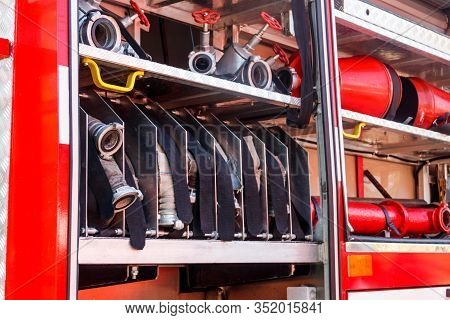 Rescue Fire Truck Equipment. Compartment Of The Rolled Up Fire Hoses On A Fire Engine