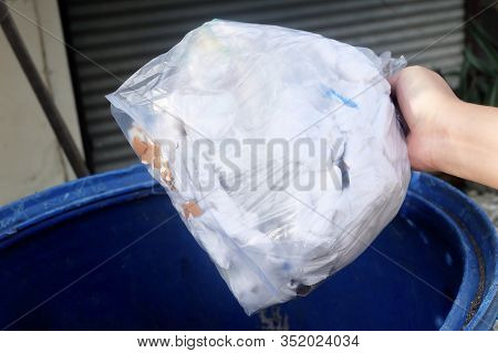 Hand Taking Out Garbage Bag In Trash Bucket Or Garbage Bin, Wastebin, Recycling Bin For Save The Ear