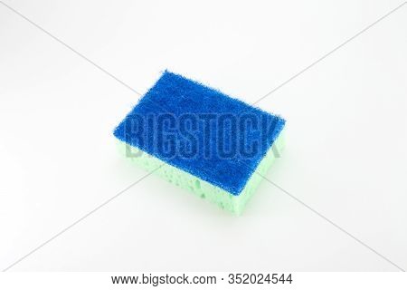 Sponge For Washing Dishes In Light Green With A Blue Abrasive Part On A White Isolated Background. R