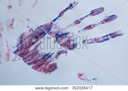 Imprint Of A Female Hand In Watercolor Paint On A White Background Close-up