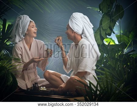Portrait Of Young Beautiful Women Drinking Tea  In Spa Environment.