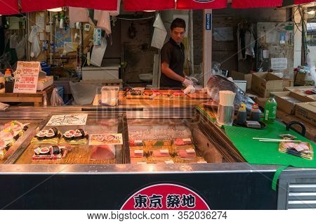 Tokyo, Japan - August 30, 2016: Fresh Fish Shop With Vendor In Tsukuji Fish Market Selling Fresh Fis