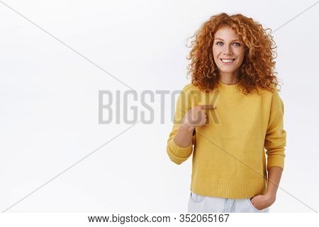 Silly Attractive Redhead Curly Woman In Yellow Sweater, Pointing Herself And Smiling, Express Person