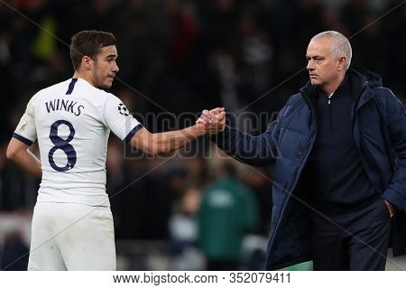LONDON, ENGLAND. 19 FEBRUARY 2020. Harry Winks shakes hands with Jose Mourinho of Tottenham during the UEFA Champions League match between Tottenham Hotspur and RB Leipzig