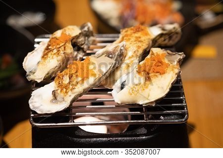 Delicious Japanese Food Grilled Oysters With Cheese And Egg Shrimp Served On Grill