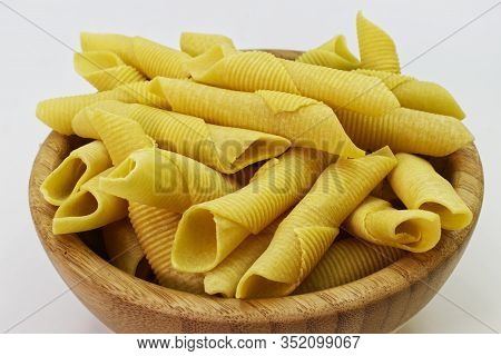 Maccheroni Al Pettine On Wooden Background. Raw Italian Pasta