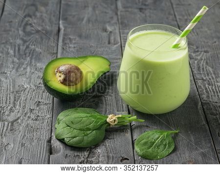 Bunch Of Spinach Leaves, Avocado And Smoothies On A Wooden Table. Fitness Product. Dietary Sports Nu