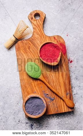 Different Colors Of Japanese Matcha Tea: Green, Red And Blue In Wooden Bowls On Gray Background. Aca