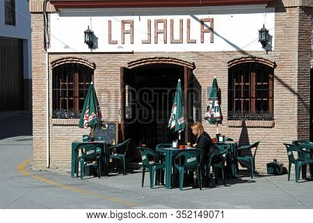 Monda, Spain - October 29, 2008 - Woman Sitting At An Outside Table At The La Jaula Cafe In The Town