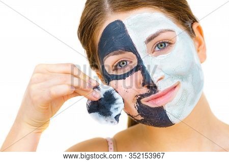 Woman With Clay Carbo Black Mask On One Half Face And White Mud On Second Half. Girl Removing Cosmet