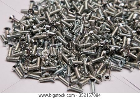 M6 Metal Screws Galvanized White In Bulk Closeup In The Studio