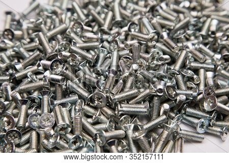 M6 Metal Screws Galvanized White In Bulk Closeup In The Studio