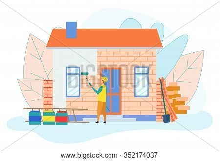 Builder Worker Painting Single Storey House Brick Wall With Paint Roller And Buckets With Dye Around