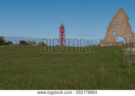 Kapelludden On Oland, Sweden. Saint Birgittas Chapel Ruin On A Sunny Spring Day. Red Lighthouse Visi