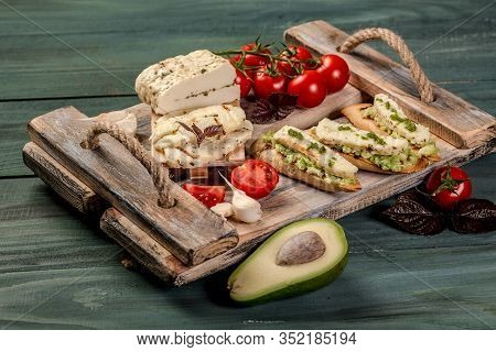 Bruschetta With Tomatoes, Avocado, Cheese, Tomatoes. Delicious Sandwiches And Toasts. Vegetarian Who