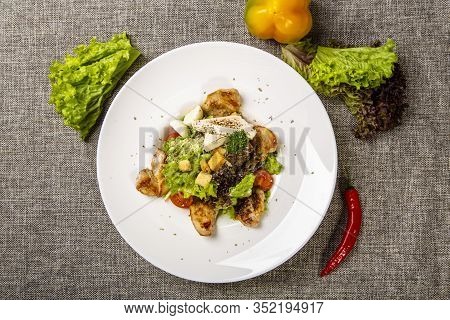 Salad With Black Sea Rapan Meat, Dressed With Honey Sauce. With Rye Crackers. On A Gray Canvas Cloth