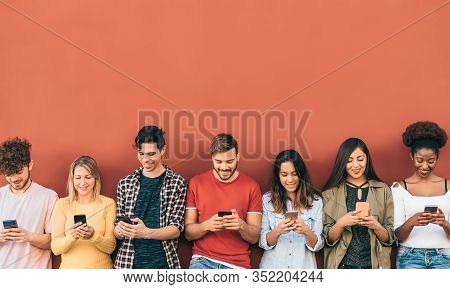 Group Young People Using Mobile Smartphone Outdoor - Millennial Generation Having Fun With New Trend