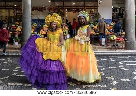 Funchal, Madeira, Portugal - April 23, 2018: Two Beautiful Girls In Yellow Dresses Encourage Shoppin