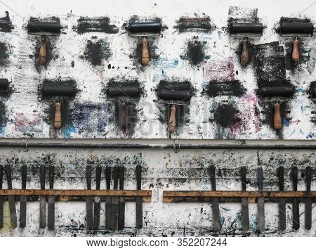 Printmaking Rollers Hanging On An Art Studio Wall In The Messy Workshop