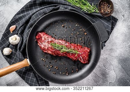 Raw Strip Vegas Steak In A Pan With Cooking Ingredients. Gray Background. Top View