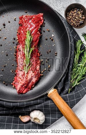 Raw Skirt, Machete Steak In A Pan With Cooking Ingredients. Gray Background. Top View