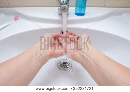 Woman Washing Hands Under The Faucet With Water, Hygiene And Profilactics Concept.