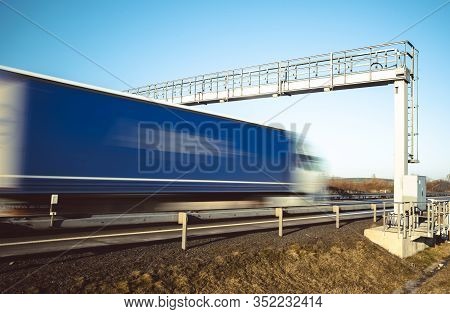 Truck Drive Through The Highway Through The Toll Gate, Toll Charges, Blurred Motion In The Image