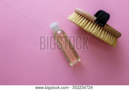 Spa Organic Brush For Dry Massage And A Bottle Of Body Oil On Pink Background. Cactus Brush And Jar 