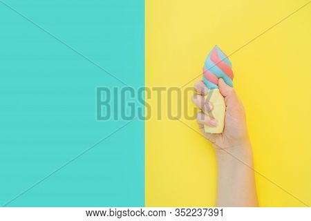 Flat Lay Antistress Toy Squish Ice Cream In Waffle Cone Squezzed In Hand.bright Blue Yellow Backgrou