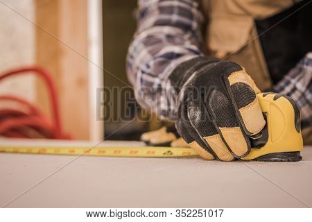 Sheetrock Drywall Measuring By Construction Worker. Closeup Industrial Photo.