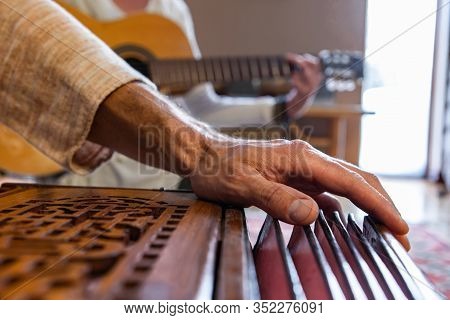 Closeup Of Senior Hands Playing Indian Classical Sacred Kirtan Music For Silence And Peace Using Har