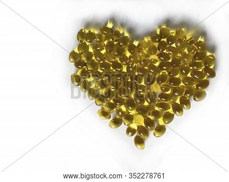 Yellow Vitamins In The Shape Of A Heart